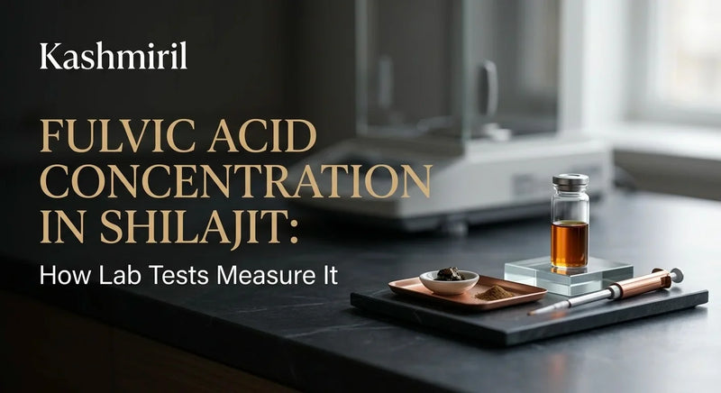 Kashmiril - FULVIC ACID CONCENTRATION IN SHILAJIT: How Lab Tests Measure It. Shilajit resin, powder, and amber liquid vial arranged with lab tools on dark marble tray in modern setting.