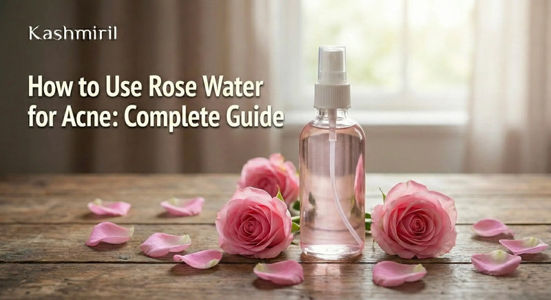 Rose water spray bottle with pink roses and petals on wooden table - How to Use Rose Water for Acne Complete Guide by Kashmiril