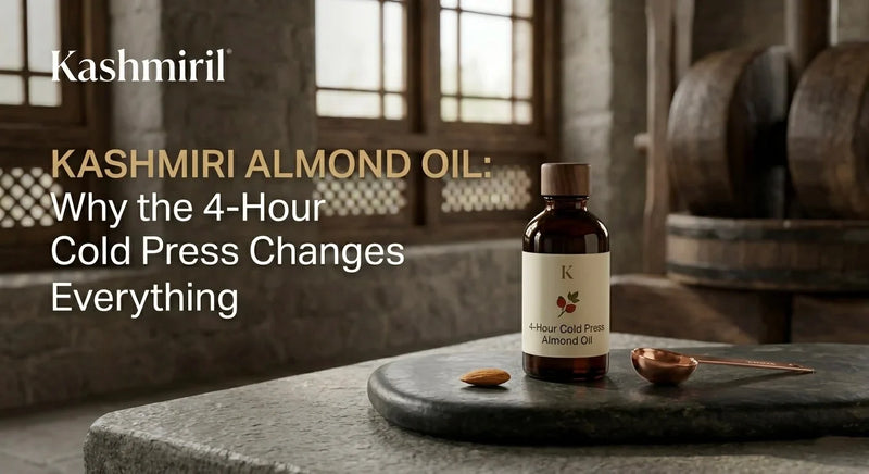 Kashmiril | KASHMIRI ALMOND OIL: Why the 4-Hour Cold Press Changes Everything. Elegant bottle of 4-Hour Cold Press Almond Oil on stone slab with almond and copper spoon in rustic setting.