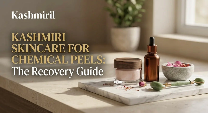 KASHMIRI SKINCARE FOR CHEMICAL PEELS: The Recovery Guide by Kashmiril. Elegant display of cream jar, amber serum bottle, jade roller, and saffron petals arranged on a marble tray by a sunny window.