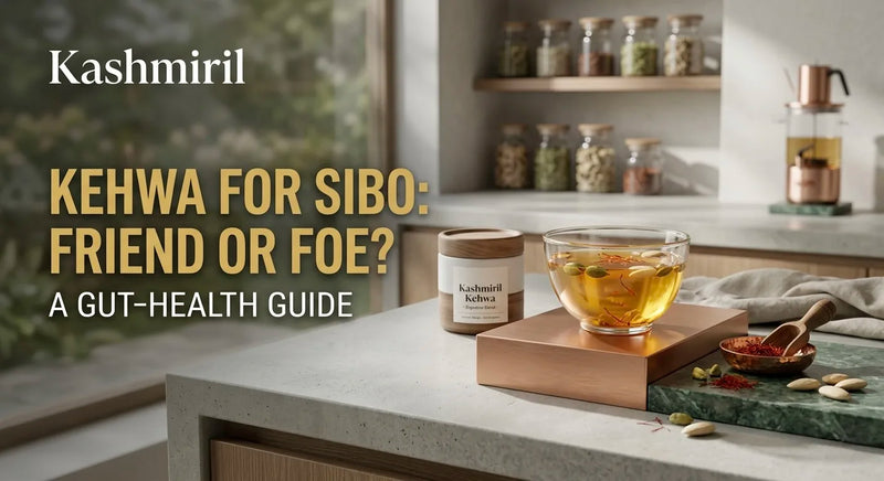 Kashmiril - KEHWA FOR SIBO: FRIEND OR FOE? A GUT-HEALTH GUIDE. Glass of saffron kehwa with Kashmiril tin on a modern kitchen counter.