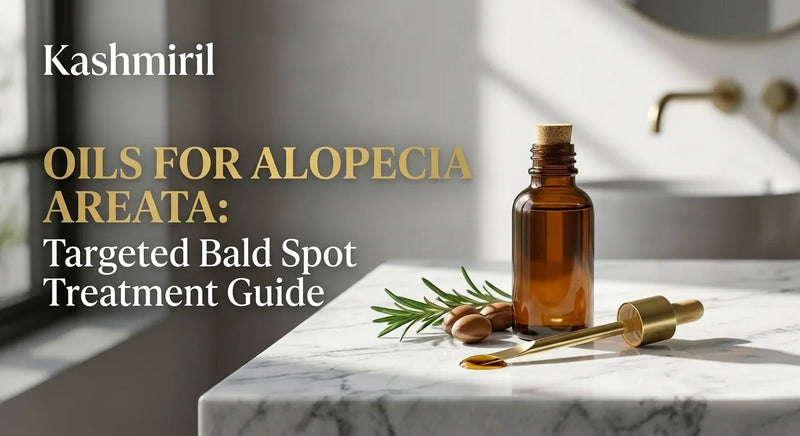 OILS FOR ALOPECIA AREATA: Targeted Bald Spot Treatment Guide by Kashmiril. Amber oil bottle with dropper on white marble surface, paired with rosemary and almonds in a bright, modern bathroom setting.