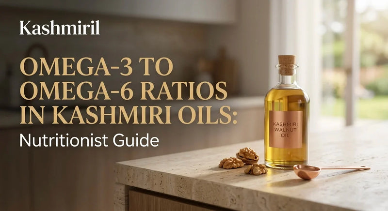 Kashmiril - OMEGA-3 TO OMEGA-6 RATIOS IN KASHMIRI OILS: Nutritionist Guide. Glass bottle of Kashmiri walnut oil with walnuts and copper spoon on marble kitchen counter.