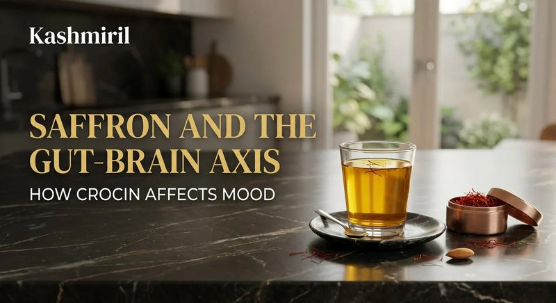 Saffron and the Gut-Brain Axis: How Crocin Affects Mood - A glass of saffron tea and a copper tin of threads on a dark marble counter.