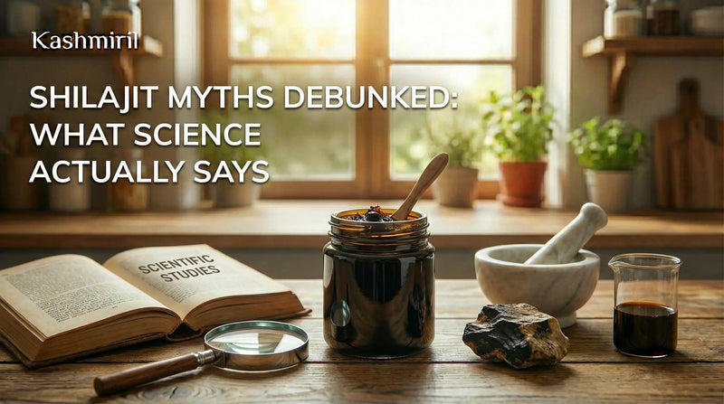 Shilajit Myths Debunked: What Science Actually Says — Kashmiril blog featured image showing a jar of Shilajit resin, scientific studies book, magnifying glass, mortar and pestle, and raw Shilajit rock on a wooden table.