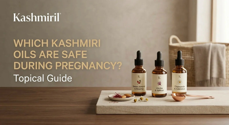 Kashmiril | WHICH KASHMIRI OILS ARE SAFE DURING PREGNANCY? Topical Guide. Three amber dropper bottles of pregnancy-safe oils (Sweet Almond & Rosehip, Jojoba & Saffron, Chamomile & Calendula) on marble tray with botanicals.