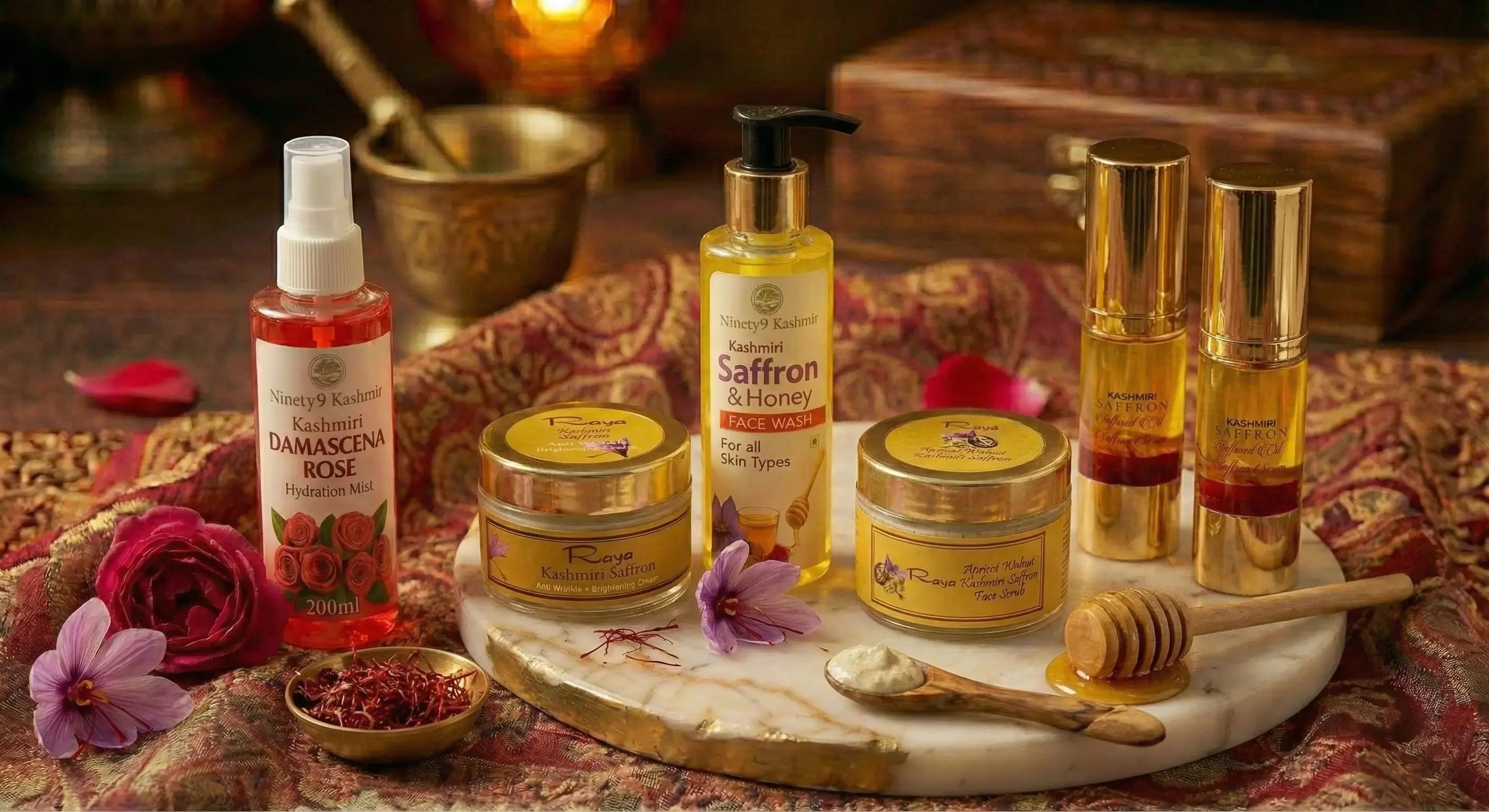 Complete Kashmiri saffron skincare collection featuring Raya cream, face wash, serum, scrub, and rose mist with saffron threads and crocus flowers