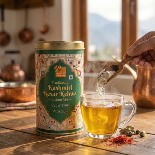 Cylindrical container of Kashmiri Kesar Kehwa powder with a glass of tea on a wooden table.