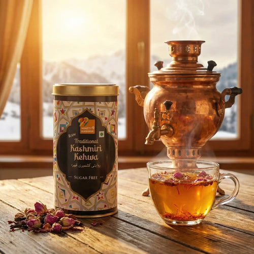 Copper samovar with a cup of tea and a canister labeled 'Traditional Kashmiri Kehwa' on a wooden table.