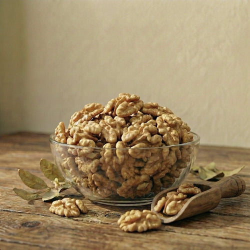 White bowl filled with walnuts on a beige background