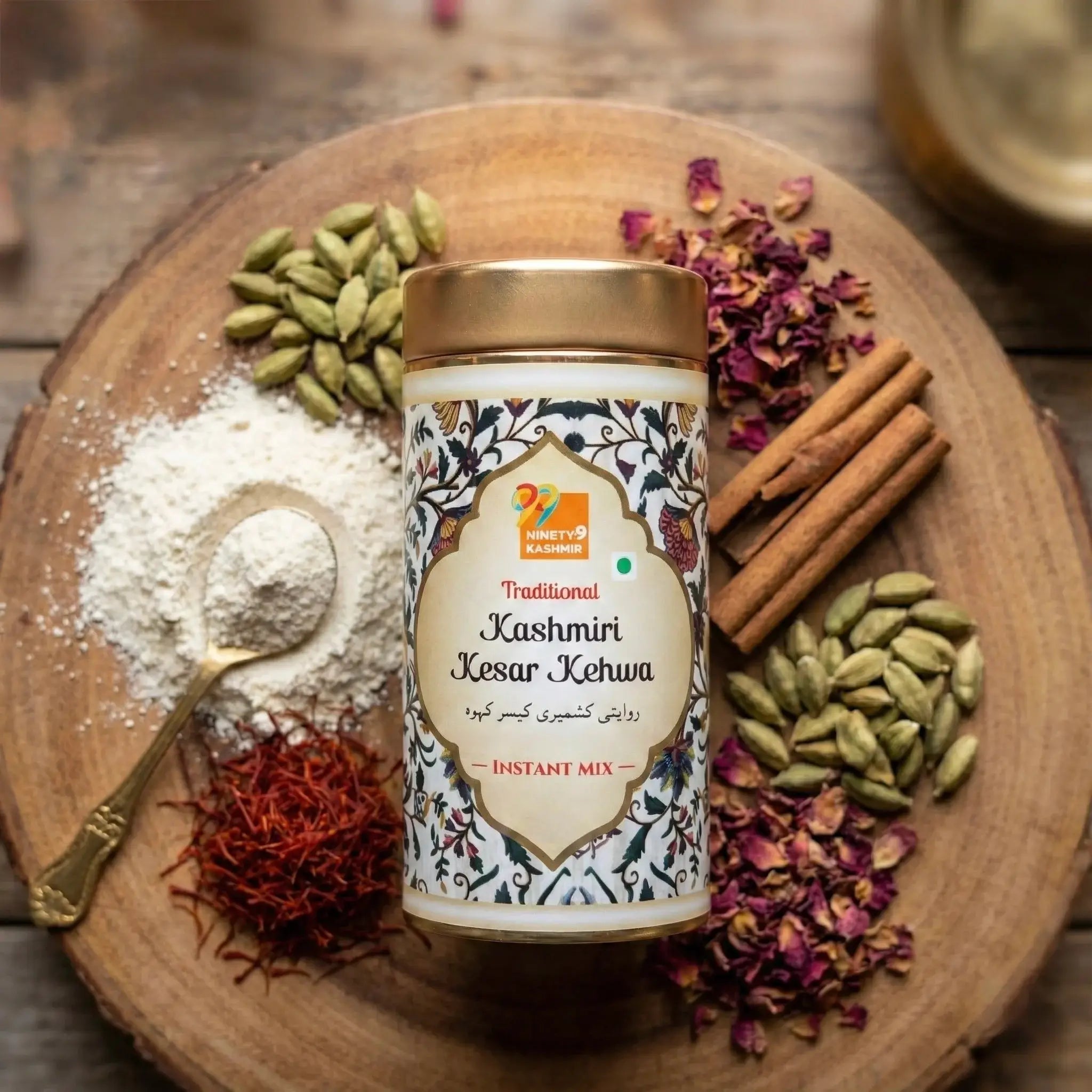 Kashmiri Kesar Kehwa instant mix container surrounded by spices on a wooden board